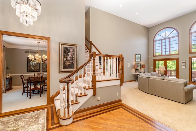 2090 Edenderry Dr, Fort Mitchell, KY 41017 - stairway featuring a chandelier, a towering ceiling, carpet, baseboards, and crown molding