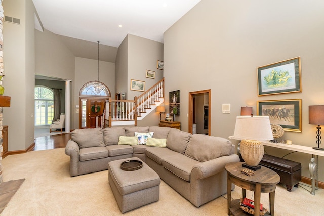 2090 Edenderry Dr, Fort Mitchell, KY 41017 - living area with high vaulted ceiling, stairs, carpet flooring, a fireplace, and baseboards