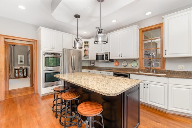 2090 Edenderry Dr, Fort Mitchell, KY 41017 - kitchen featuring stainless steel appliances, a kitchen island, white cabinets, and recessed lighting