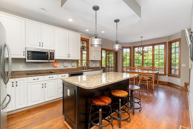 2090 Edenderry Dr, Fort Mitchell, KY 41017 - kitchen featuring appliances with stainless steel finishes, light wood-style floors, a center island, white cabinetry, and recessed lighting