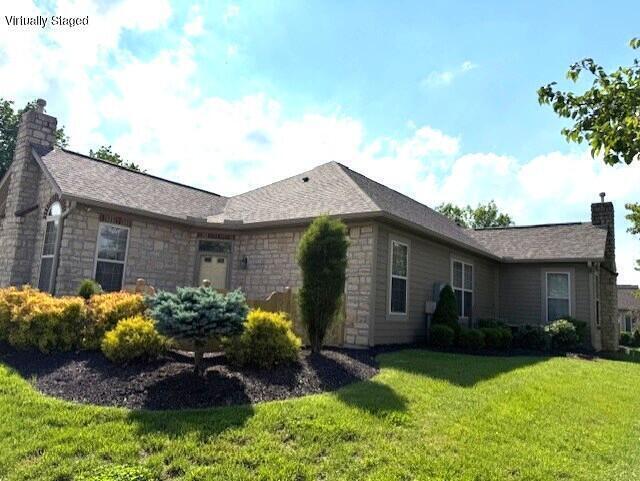 9072 Timberbrook Ln Unit B, Florence, KY 41042 - view of side of home with a chimney, stone siding, and a yard