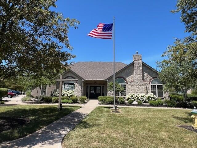 9072 Timberbrook Ln Unit B, Florence, KY 41042 - view of front facade with stone siding, a front lawn, and a chimney