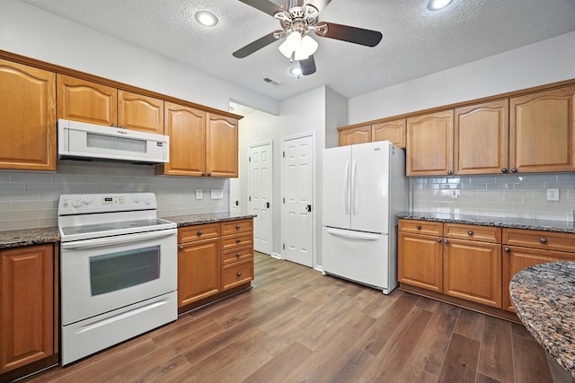 9072 Timberbrook Ln Unit B, Florence, KY 41042 - kitchen with white appliances, dark wood-type flooring, dark stone countertops, a textured ceiling, and recessed lighting