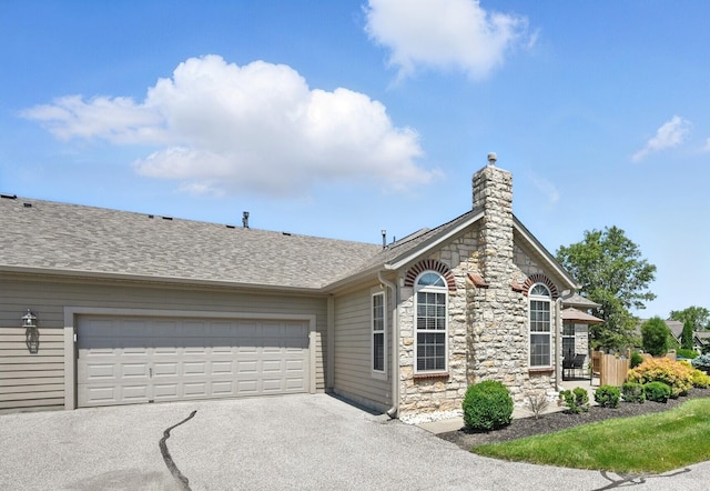 9072 Timberbrook Ln Unit B, Florence, KY 41042 - ranch-style house featuring stone siding, asphalt driveway, a garage, roof with shingles, and a chimney