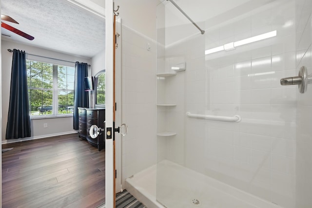 9072 Timberbrook Ln Unit B, Florence, KY 41042 - bathroom featuring a stall shower, wood finished floors, ceiling fan, a textured ceiling, and baseboards