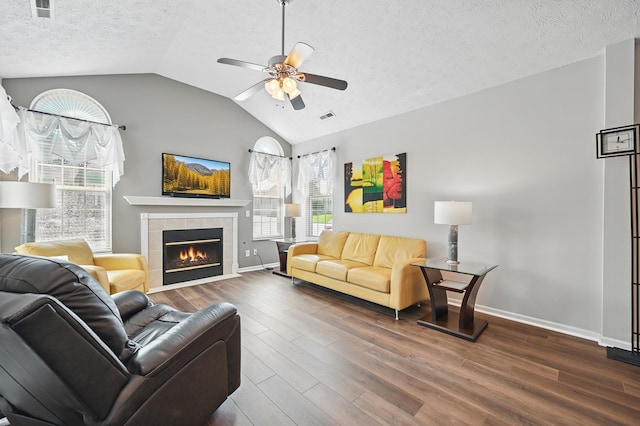 9072 Timberbrook Ln Unit B, Florence, KY 41042 - living area with ceiling fan, a tiled fireplace, wood finished floors, lofted ceiling, and a textured ceiling