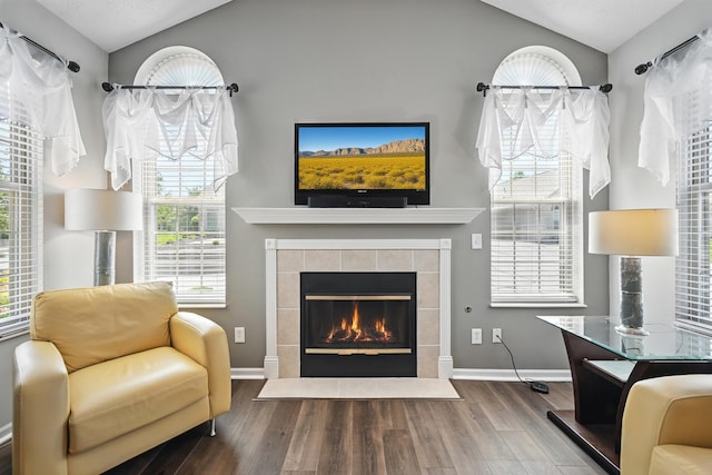 9072 Timberbrook Ln Unit B, Florence, KY 41042 - living room featuring lofted ceiling, wood finished floors, a tiled fireplace, healthy amount of natural light, and baseboards