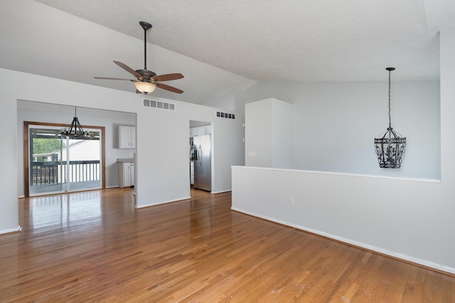1837 Asbury Way, Hebron, KY 41048 - empty room featuring lofted ceiling, ceiling fan, light wood-type flooring, baseboards, and a chandelier