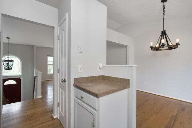 1837 Asbury Way, Hebron, KY 41048 - kitchen with a chandelier, wood finished floors, white cabinets, and lofted ceiling