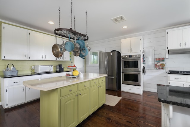 1120 Keefer Rd, Corinth, KY 41010 - kitchen with appliances with stainless steel finishes, dark wood finished floors, under cabinet range hood, white cabinets, and a center island