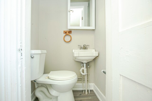 1707 Eastern Ave Unit 1709, Covington, KY 41014 - bathroom with toilet, baseboards, and wood finished floors