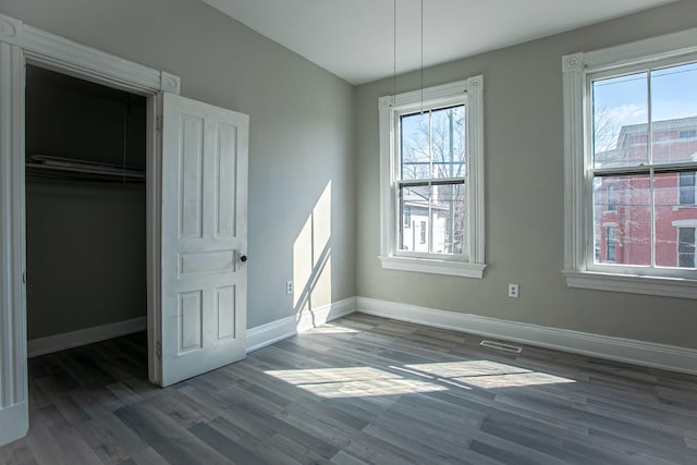 1707 Eastern Ave Unit 1709, Covington, KY 41014 - unfurnished bedroom with baseboards, wood finished floors, and multiple windows