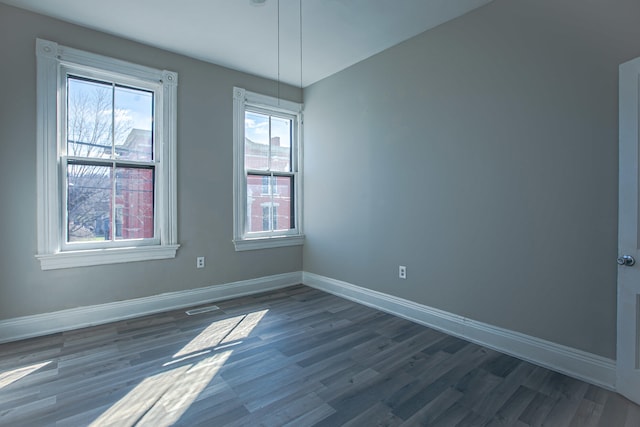 1707 Eastern Ave Unit 1709, Covington, KY 41014 - empty room featuring healthy amount of natural light, baseboards, and dark wood-type flooring