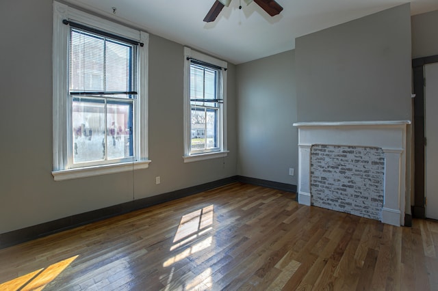 1707 Eastern Ave Unit 1709, Covington, KY 41014 - unfurnished living room with plenty of natural light, a ceiling fan, wood finished floors, and a glass covered fireplace