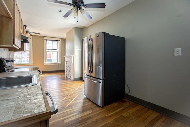 1707 Eastern Ave Unit 1709, Covington, KY 41014 - kitchen with appliances with stainless steel finishes, ceiling fan, dark wood-type flooring, baseboards, and brown cabinets