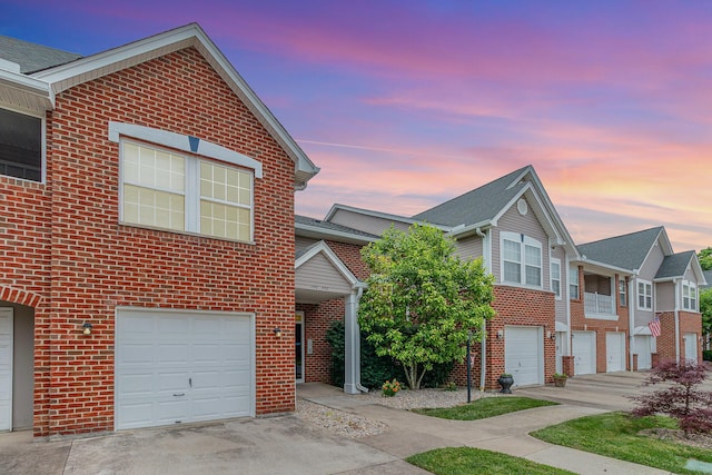 202 Langshire Ct, Florence, KY 41042 - view of front of home featuring brick siding, an attached garage, and driveway