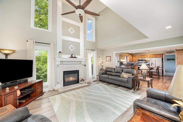 10659 Mountain Laurel Way, Union, KY 41091 - living area with a high ceiling, a ceiling fan, a tiled fireplace, light wood finished floors, and recessed lighting