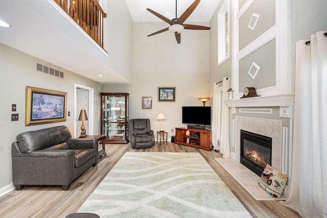 10659 Mountain Laurel Way, Union, KY 41091 - living area with ceiling fan, wood finished floors, healthy amount of natural light, a premium fireplace, and a towering ceiling