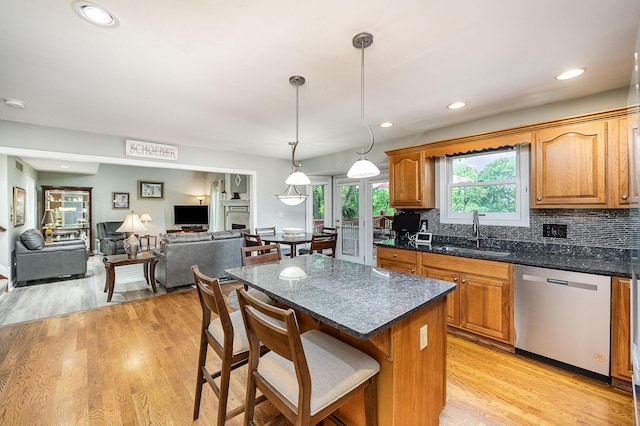 10659 Mountain Laurel Way, Union, KY 41091 - kitchen featuring stainless steel dishwasher, a sink, a kitchen bar, a center island, and light wood-type flooring