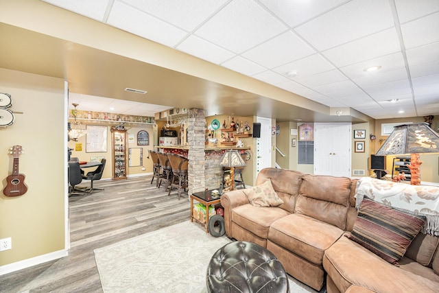 10659 Mountain Laurel Way, Union, KY 41091 - living room featuring a bar, a paneled ceiling, baseboards, and wood finished floors