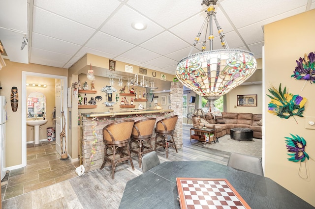 10659 Mountain Laurel Way, Union, KY 41091 - dining space featuring a paneled ceiling, a dry bar, baseboards, and decorative columns