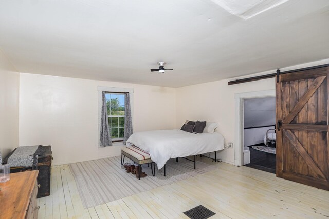 605 Lemon Northcutt Rd, Dry Ridge, KY 41035 - bedroom featuring light wood-type flooring, a barn door, and a ceiling fan