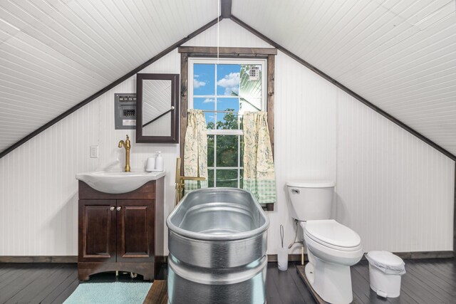 605 Lemon Northcutt Rd, Dry Ridge, KY 41035 - bathroom featuring lofted ceiling, vanity, toilet, hardwood / wood-style flooring, and baseboards