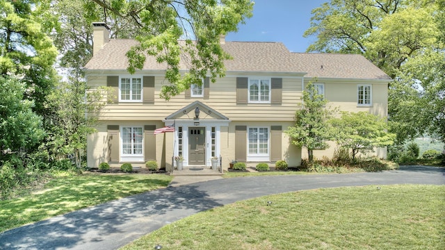 141 Manor Ln, Fort Thomas, KY 41075 - colonial inspired home featuring a chimney, a front lawn, asphalt driveway, and a shingled roof
