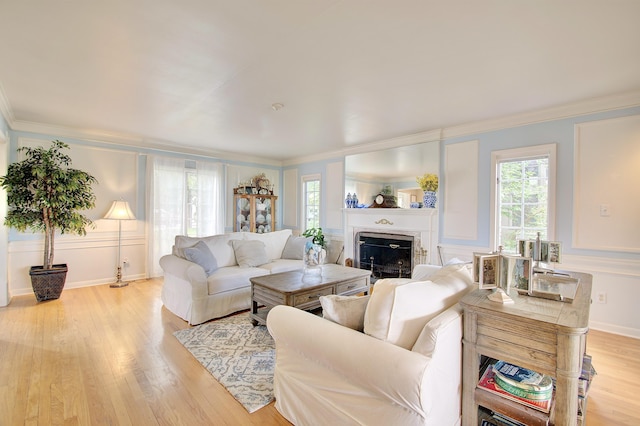 141 Manor Ln, Fort Thomas, KY 41075 - living area featuring light wood-style flooring, crown molding, and a fireplace