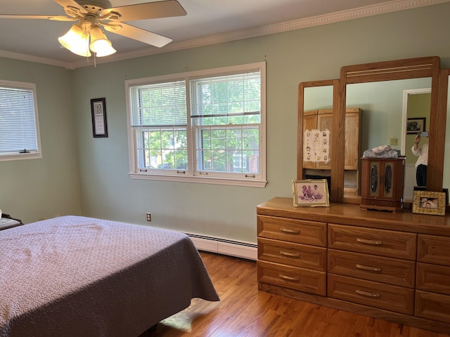 11 Alanna Dr, Wilder, KY 41076 - bedroom featuring a baseboard heating unit, crown molding, wood finished floors, and ceiling fan