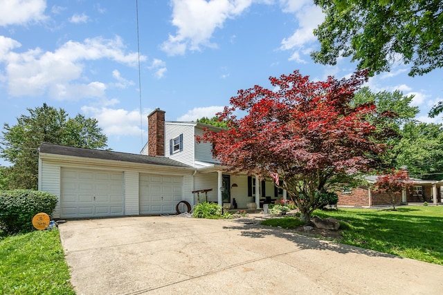 2919 Watts Rd, Burlington, KY 41005 - view of front of property with a garage, a chimney, concrete driveway, a front yard, and a porch