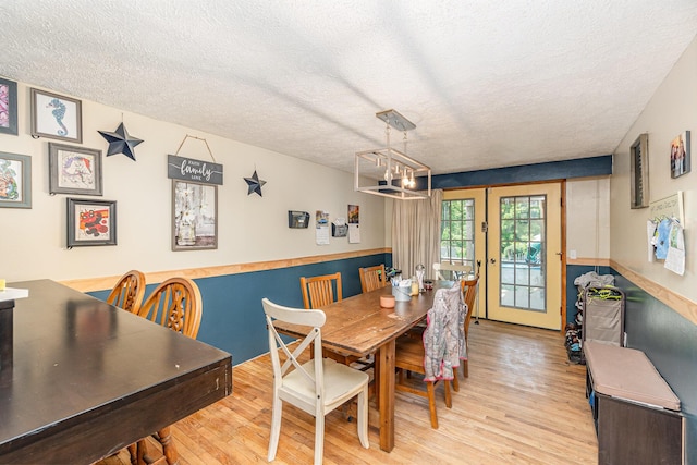 2919 Watts Rd, Burlington, KY 41005 - dining space with light wood-style flooring, a textured ceiling, and a chandelier