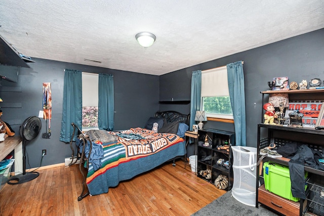 2919 Watts Rd, Burlington, KY 41005 - bedroom with wood finished floors, a textured ceiling, and baseboards