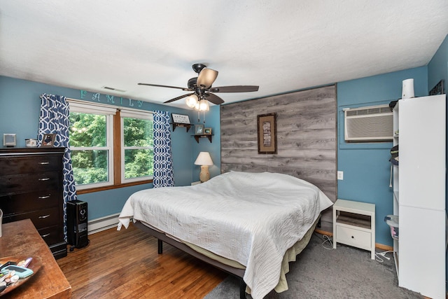 2919 Watts Rd, Burlington, KY 41005 - bedroom featuring a baseboard heating unit, a wall unit AC, baseboards, a ceiling fan, and an accent wall