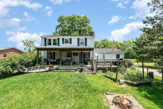 2919 Watts Rd, Burlington, KY 41005 - back of house with a vegetable garden, a lawn, a chimney, and a deck