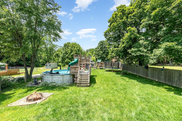 2919 Watts Rd, Burlington, KY 41005 - view of yard featuring a playground, an outdoor fire pit, a trampoline, and view of scattered trees