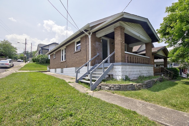 1823 Euclid Ave, Covington, KY 41014 - view of front of home featuring brick siding and a front yard