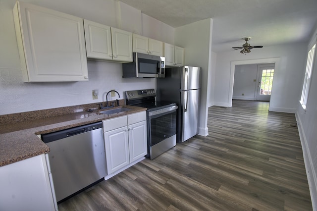 1823 Euclid Ave, Covington, KY 41014 - kitchen featuring appliances with stainless steel finishes, a sink, white cabinets, and dark wood-style floors