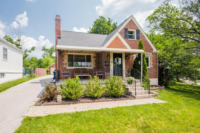 212 James Ave, Erlanger, KY 41018 - view of front of house featuring brick siding, covered porch, a front lawn, and a chimney
