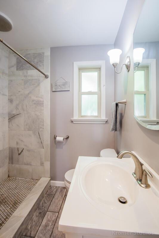 212 James Ave, Erlanger, KY 41018 - full bathroom with toilet, tiled shower, vanity, baseboards, and wood finished floors