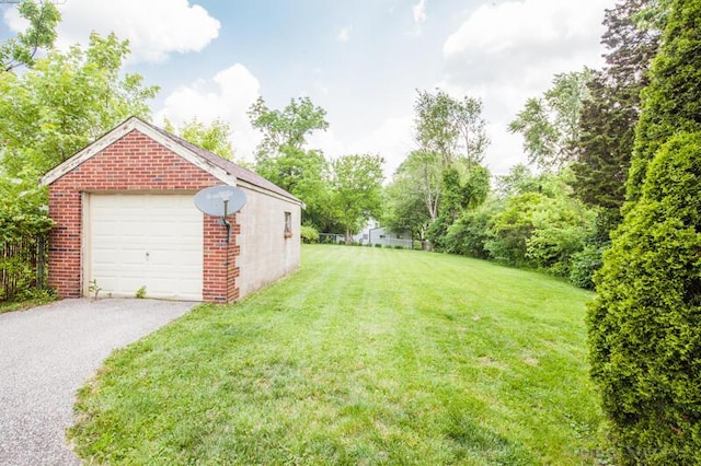 212 James Ave, Erlanger, KY 41018 - view of grassy yard with a detached garage and driveway