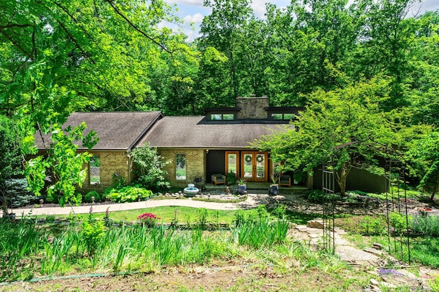 2709 Longbranch Rd, Union, KY 41091 - view of front facade featuring french doors, brick siding, a shingled roof, and a chimney