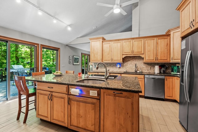 2709 Longbranch Rd, Union, KY 41091 - kitchen with appliances with stainless steel finishes, a sink, vaulted ceiling, track lighting, and light wood-style flooring