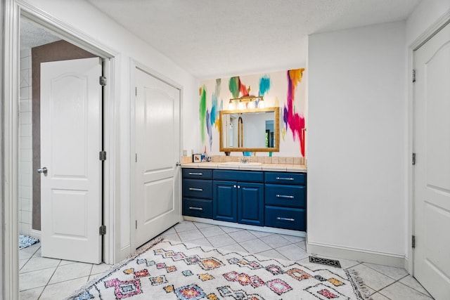 2709 Longbranch Rd, Union, KY 41091 - bathroom with vanity, tile patterned floors, baseboards, and a textured ceiling