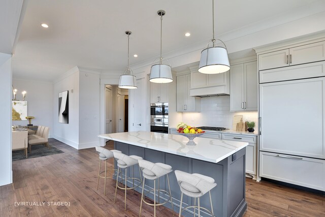 1 Highland Ave Unit 309, Fort Thomas, KY 41075 - kitchen with stainless steel appliances, a kitchen bar, backsplash, crown molding, and light stone countertops