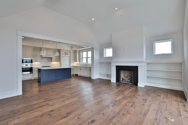 1 Highland Ave Unit 309, Fort Thomas, KY 41075 - unfurnished living room with lofted ceiling, healthy amount of natural light, a fireplace, and dark wood finished floors