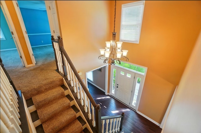 856 Moonstone Ct, Crescent Springs, KY 41017 - foyer with baseboards, a chandelier, dark wood-type flooring, and stairs