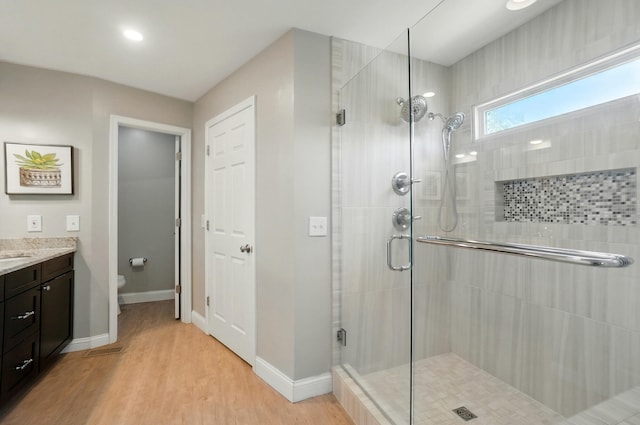 856 Moonstone Ct, Crescent Springs, KY 41017 - full bathroom with a stall shower, vanity, wood finished floors, toilet, and baseboards