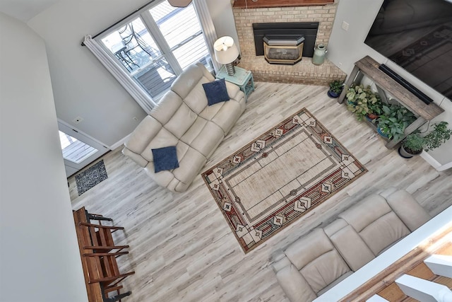 8949 E Main St, Alexandria, KY 41001 - living area with wood finished floors, a brick fireplace, and baseboards