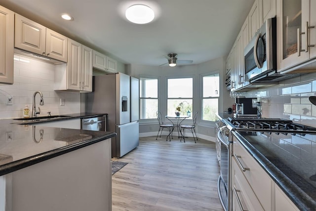 8949 E Main St, Alexandria, KY 41001 - kitchen featuring appliances with stainless steel finishes, a sink, ceiling fan, baseboards, and decorative backsplash